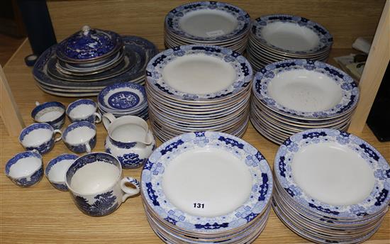 A large quantity of blue and white dinner and soup plates and sundry willow pattern wares